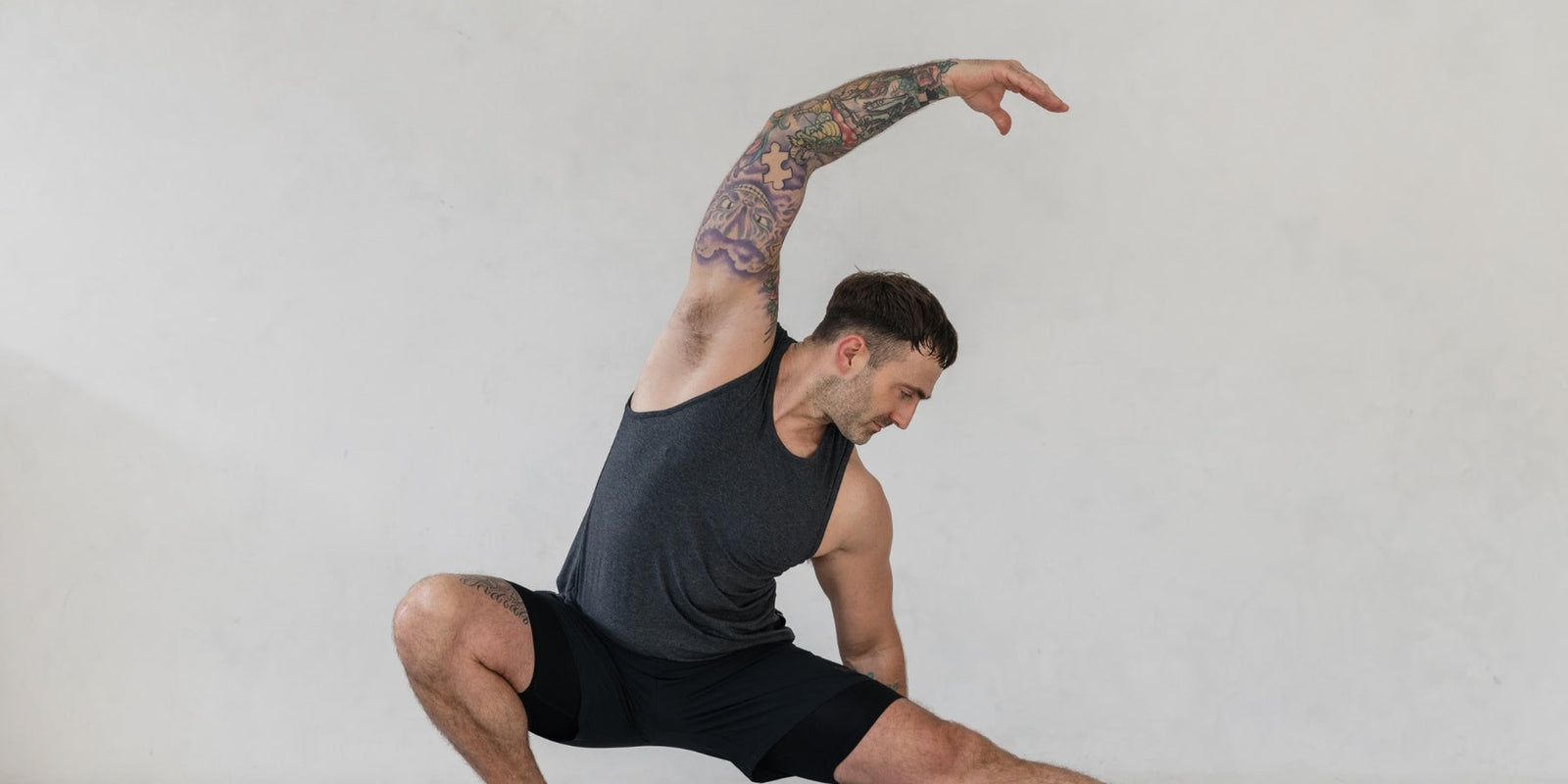 man doing yoga in warrior addict activewear