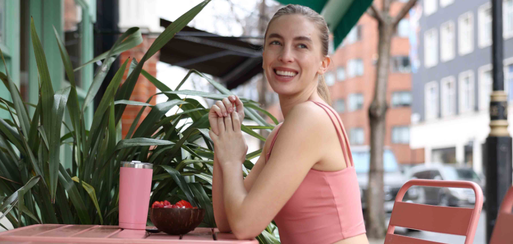 model wearing yoga outfit set in pink at cafe