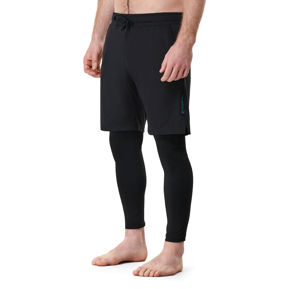 Barefoot person wearing black shorts and leggings.