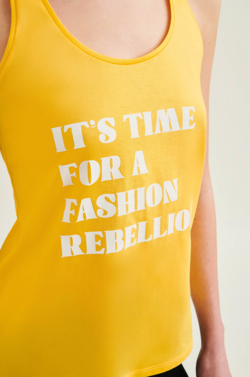 Yellow tank top with white text 'IT'S TIME FOR A FASHION REBELLION' on a plain background
