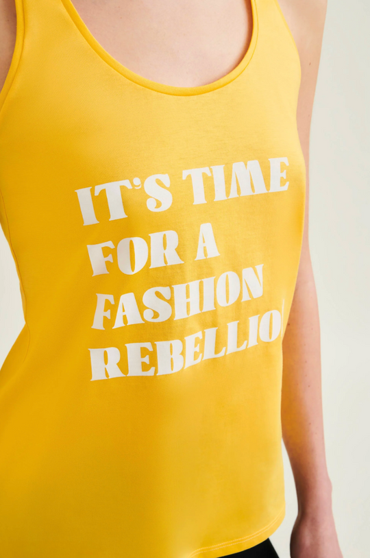 Yellow tank top with white text 'IT'S TIME FOR A FASHION REBELLION' on a plain background