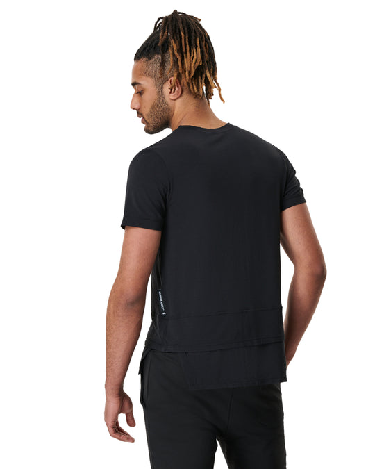 Man in black t-shirt and pants, back view.