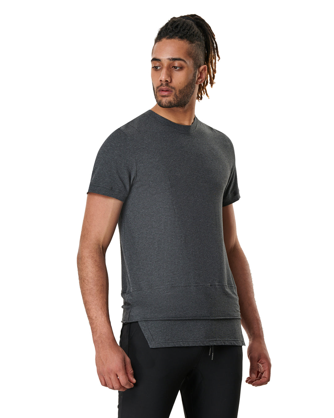 Man in heather gray shirt and black pants looking left.