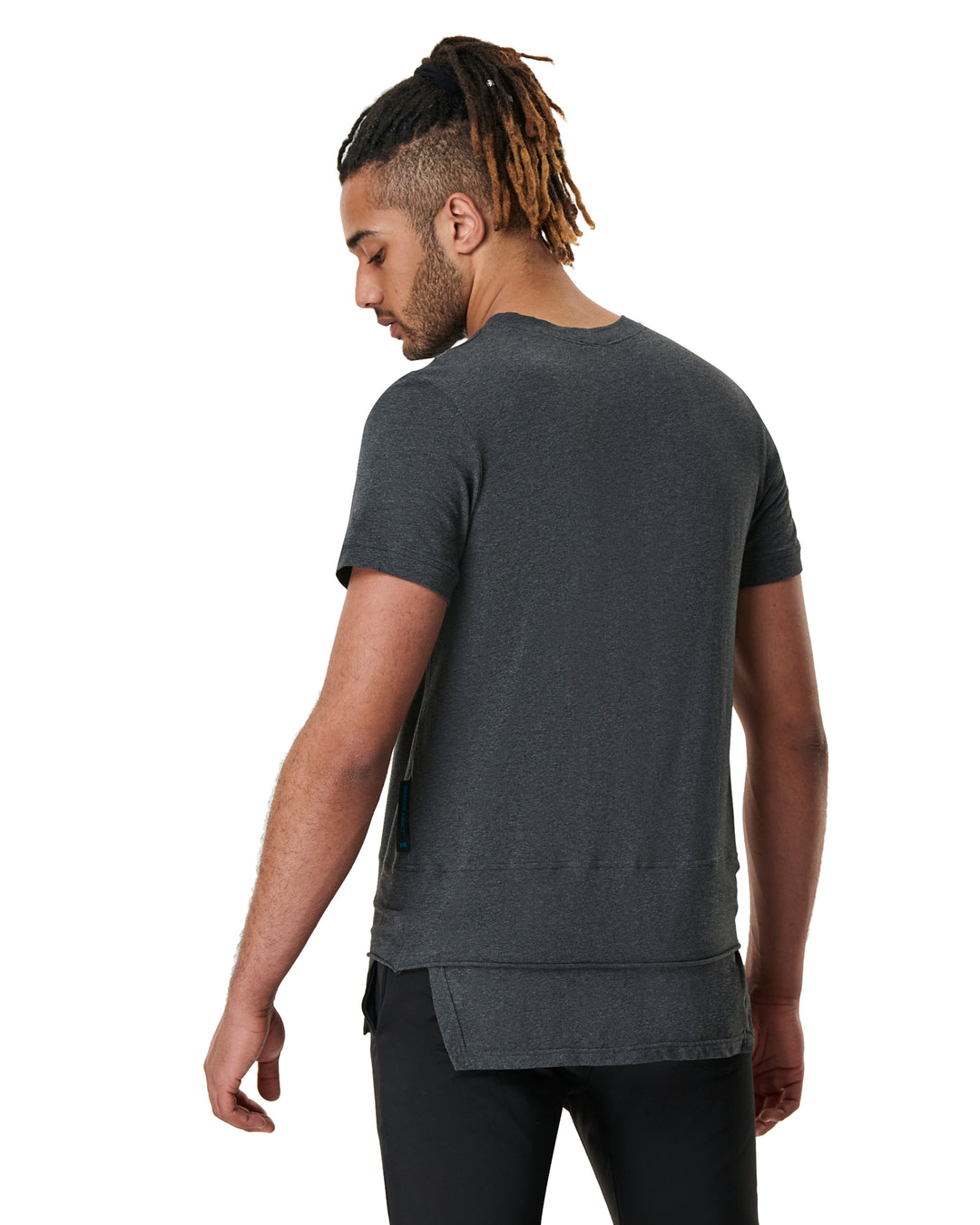 Man facing away wearing a heather grey t-shirt and black pants.