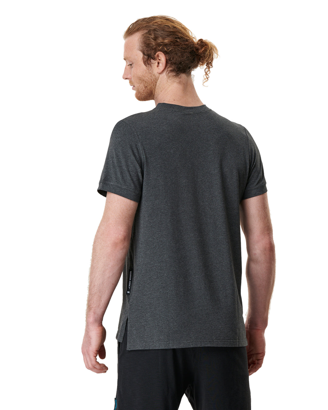 Back view of a man wearing a gray T-shirt and black shorts.