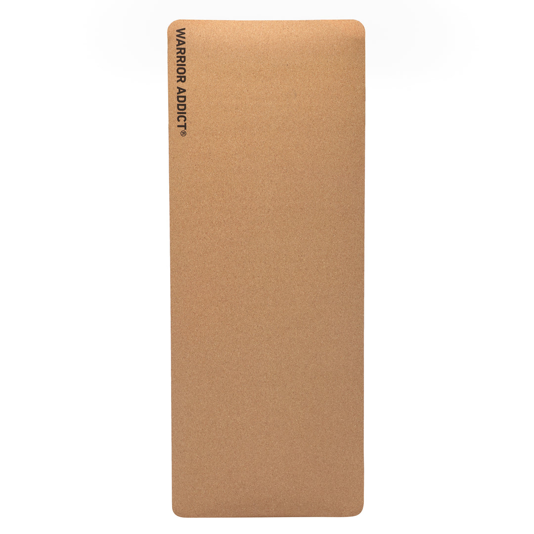 Brown cork yoga mat with the logo "WARRIOR ADDICT" in black.