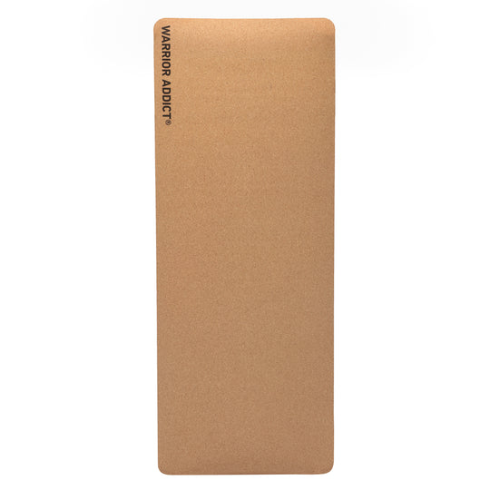 Brown cork yoga mat with the logo "WARRIOR ADDICT" in black.