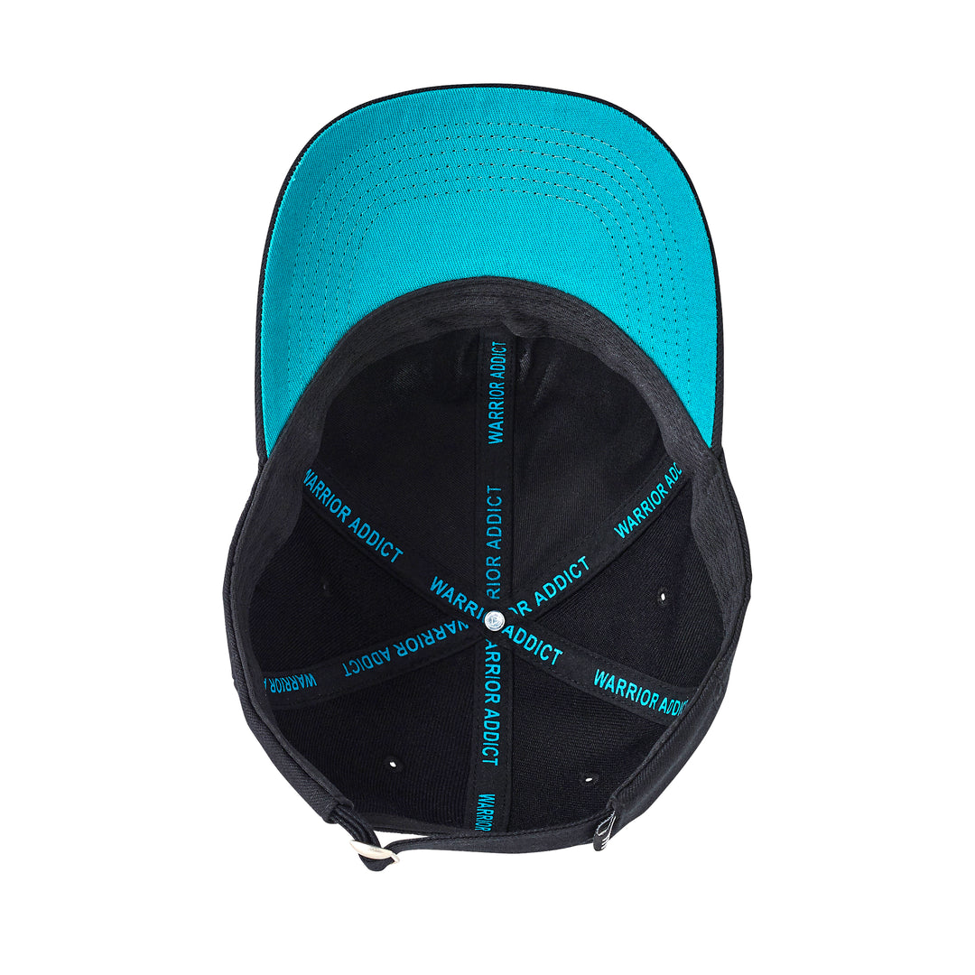 Inside view of a black baseball cap with a turquoise brim and "Warrior Addict" inscription on the inner straps.
