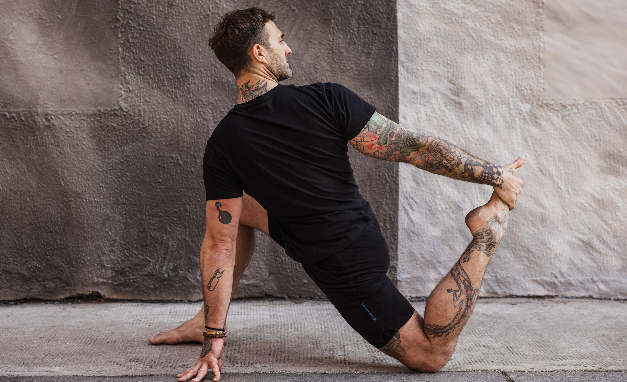 man doing yoga in mens yoga gear by warrior addict 