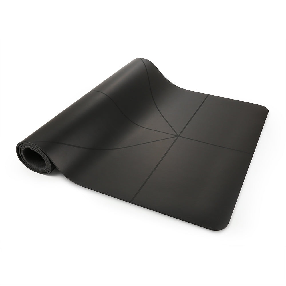 Black yoga mat, partially rolled with alignment lines.