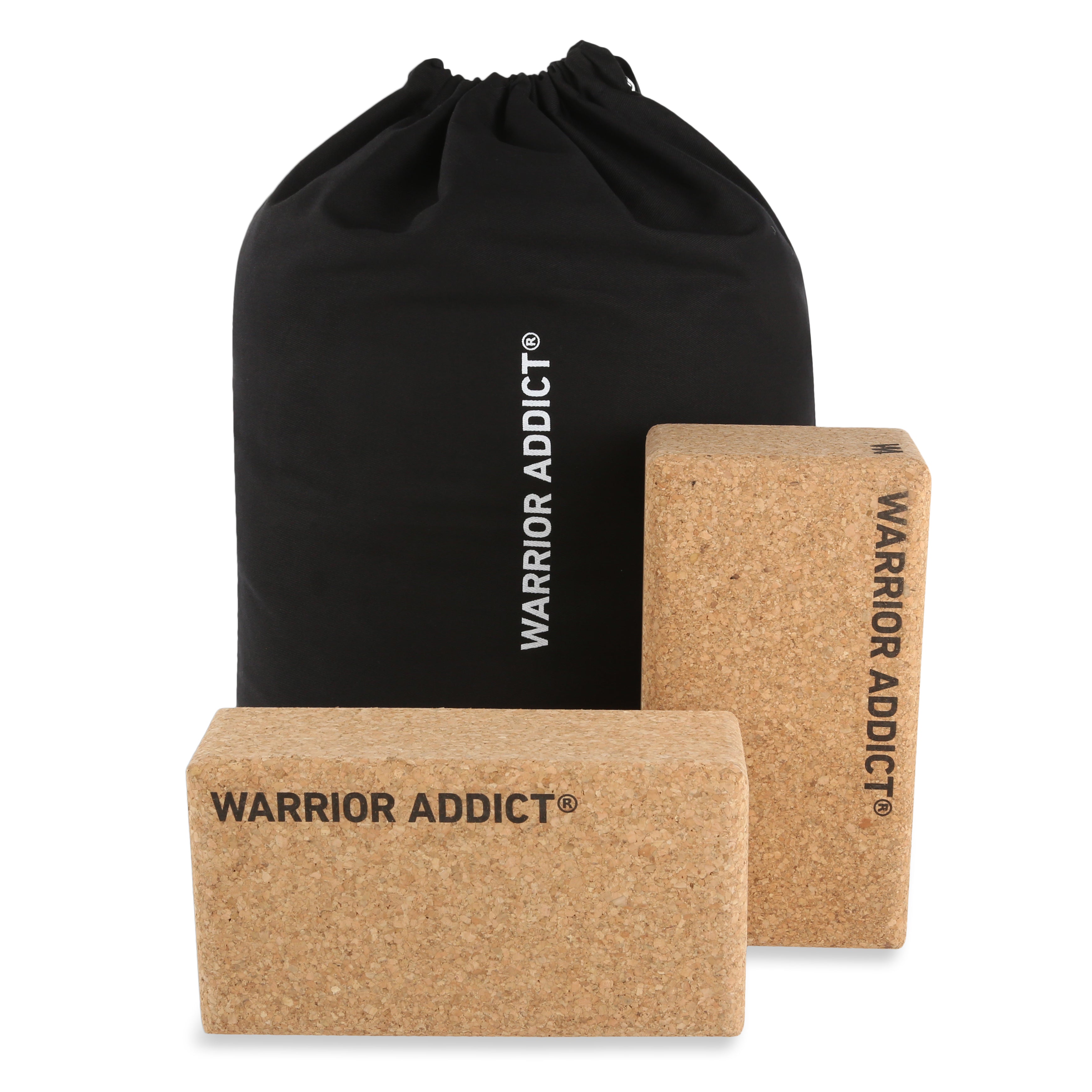 Two cork yoga blocks and a black drawstring bag with white text.