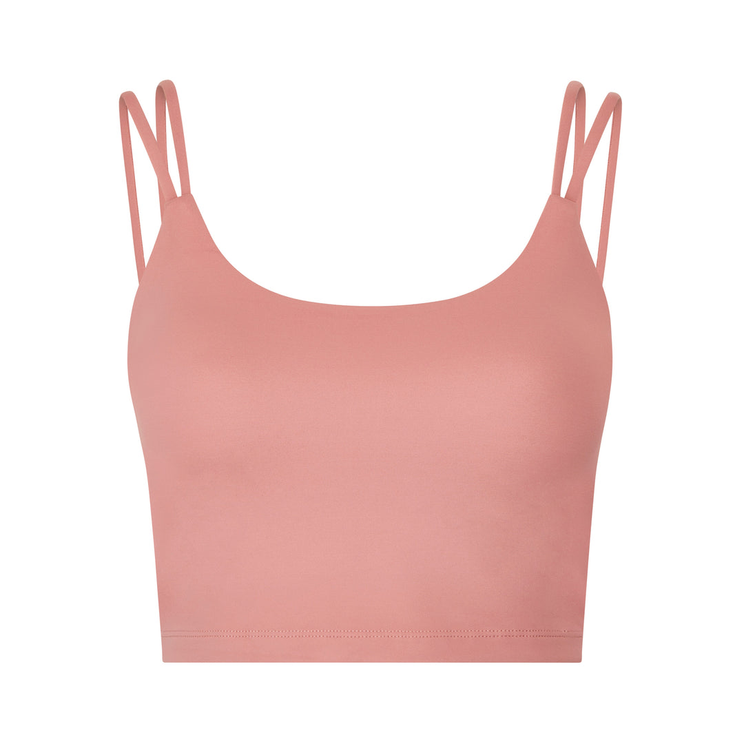 Salmon-colored sports bra top with double straps.