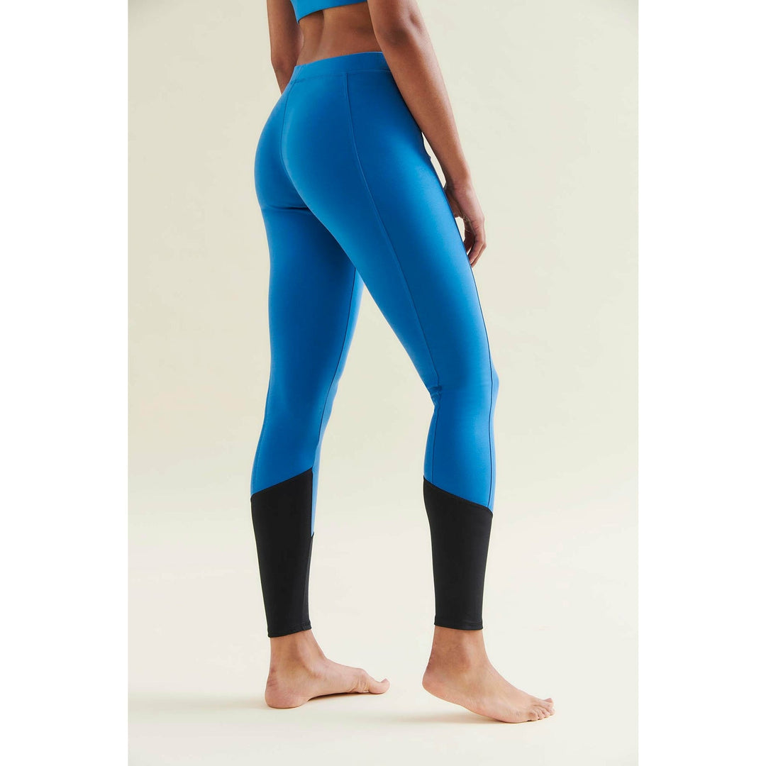 Back view of a woman in blue and black leggings.
