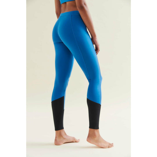 Back view of a woman in blue and black leggings.
