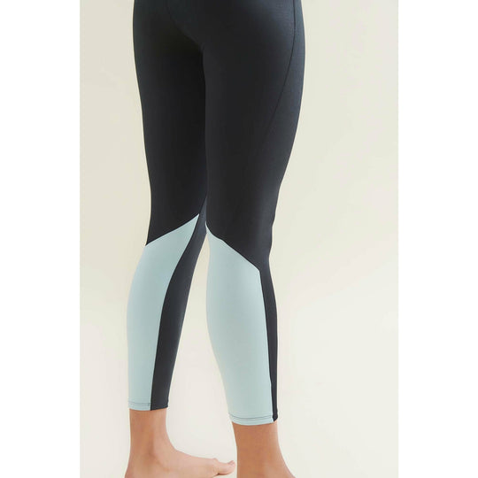 Person wearing black and mint green leggings.