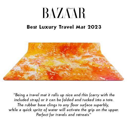 An ad for the "Best Luxury Travel Mat 2023" by Harper's Bazaar featuring a travel mat that is white, orange, and red in color with the word "KAIA" on the bottom. Below the mat is a description touting the benefits of the travel mat.