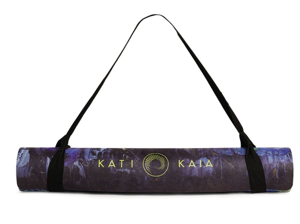Rolled yoga mat with carrying strap.