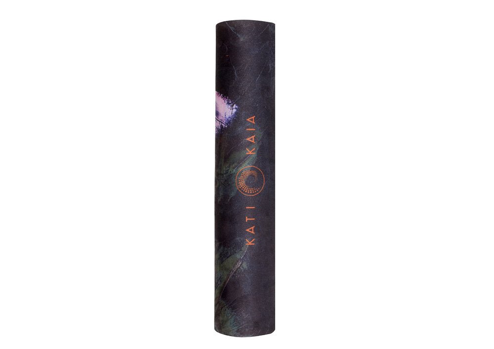 Rolled-up yoga mat with botanical print.