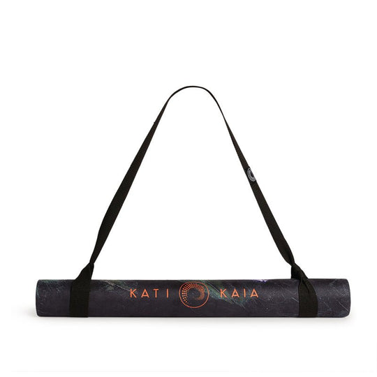 Rolled yoga mat with a carrying strap.