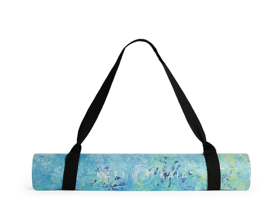 Rolled blue yoga mat with black carry strap.