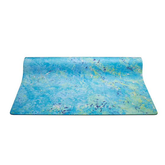 Unrolled blue and green marbled yoga mat.
