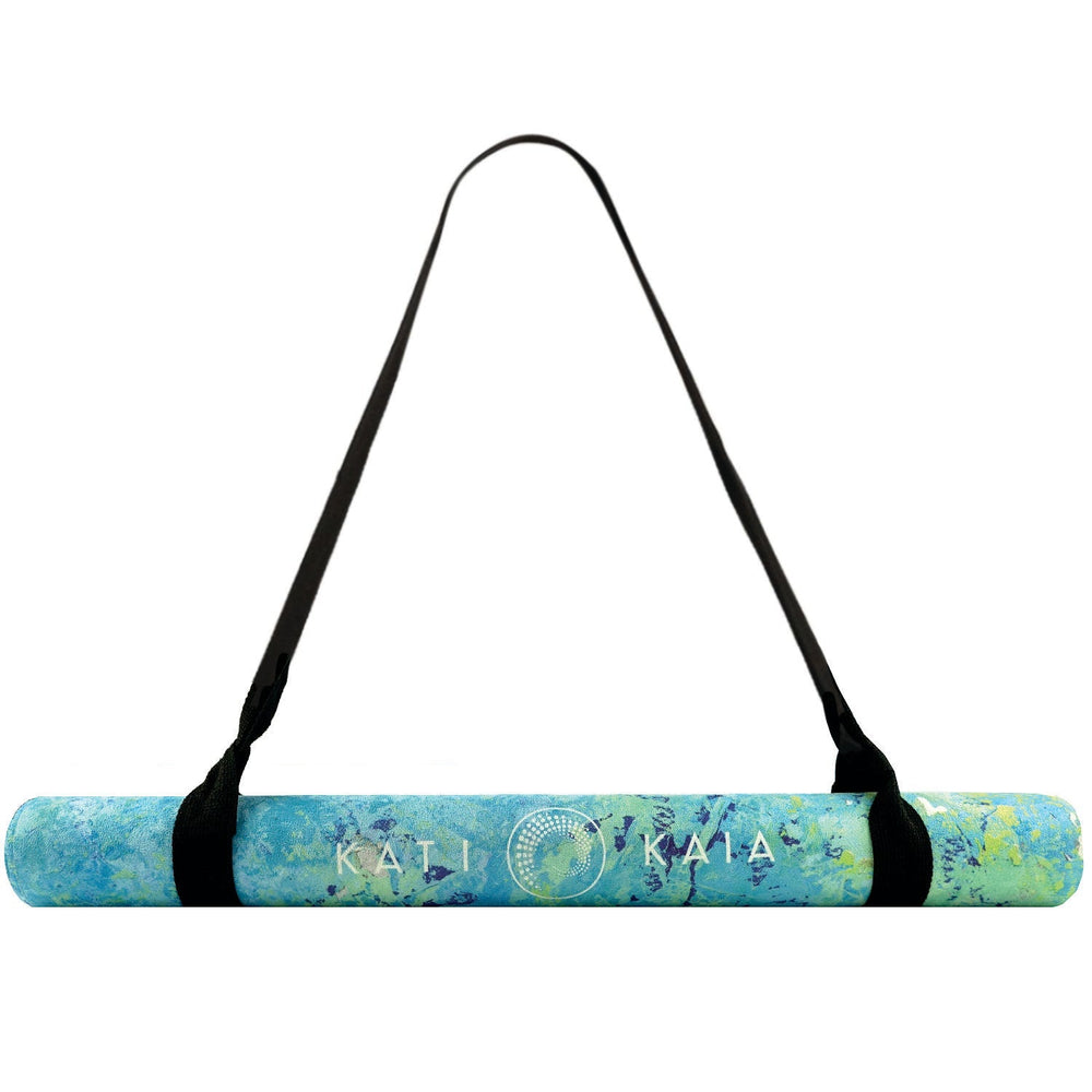 Rolled yoga mat with a strap.