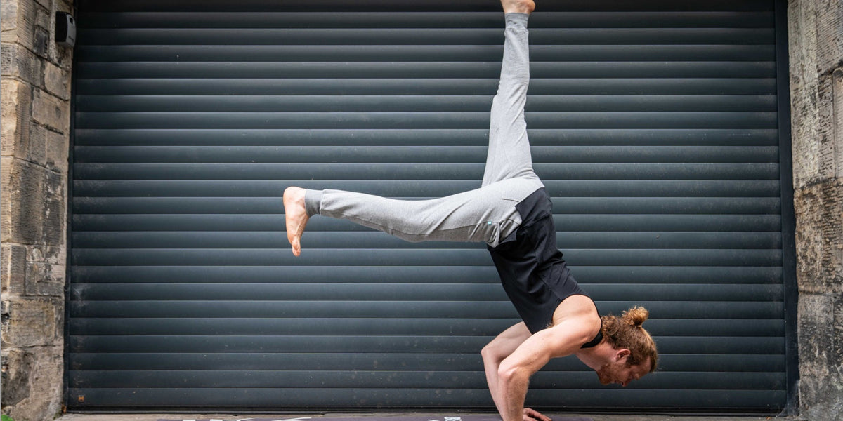 man doing hand stand in warrior addict no ride up top