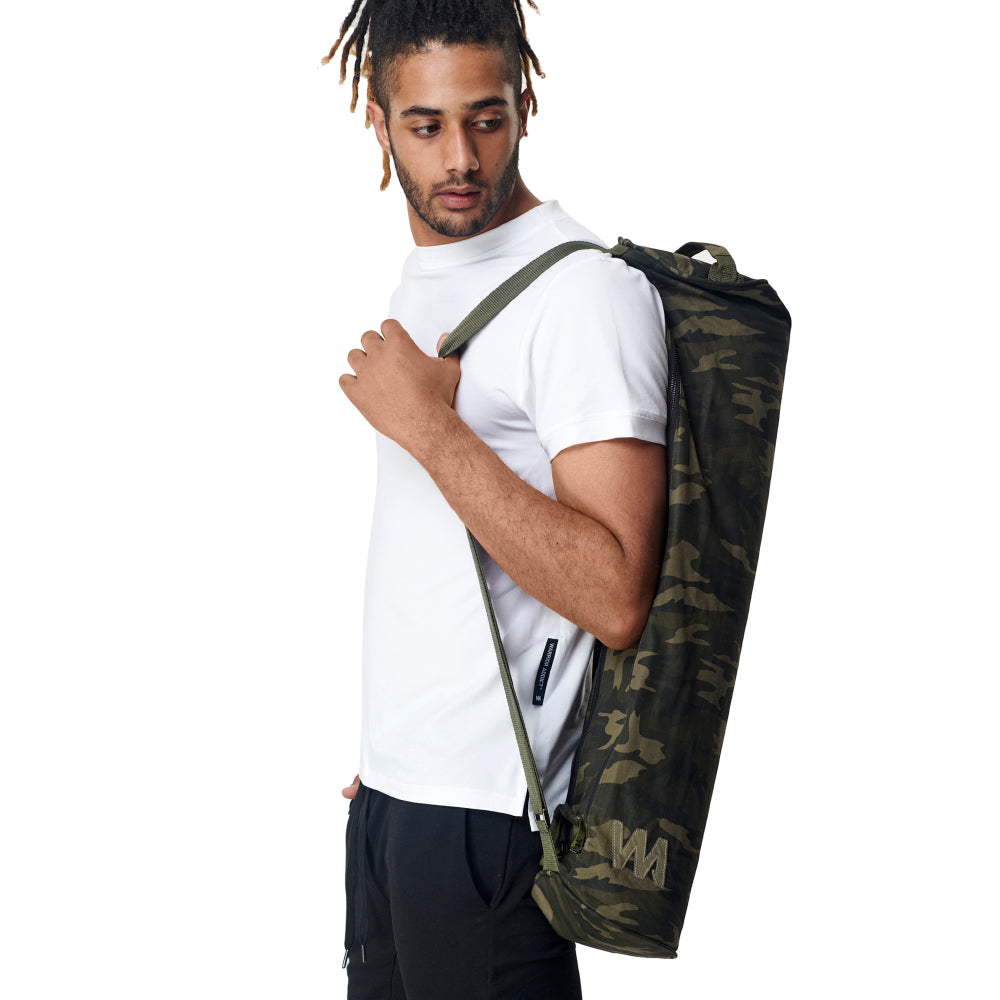 camo print extra large yoga mat carry bag by warrior addict  being carried by a model