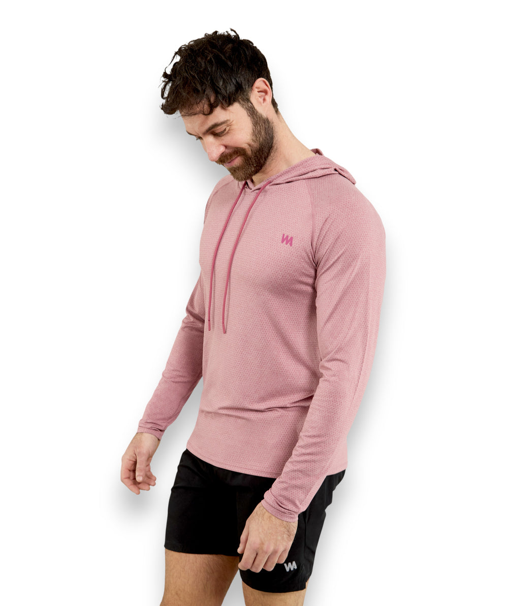 Man wearing a pink  warrior addict hoodie and black shorts on a white background