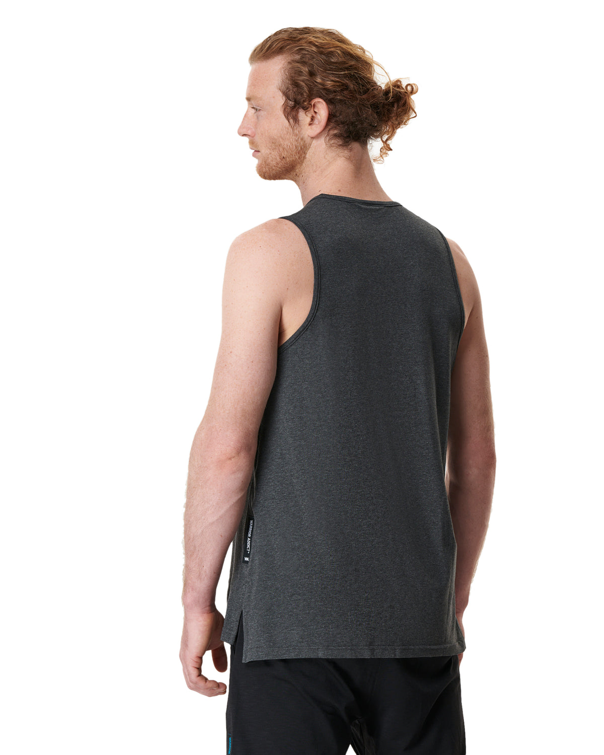man showing the back of a grey mens yoga top by warrior addict 