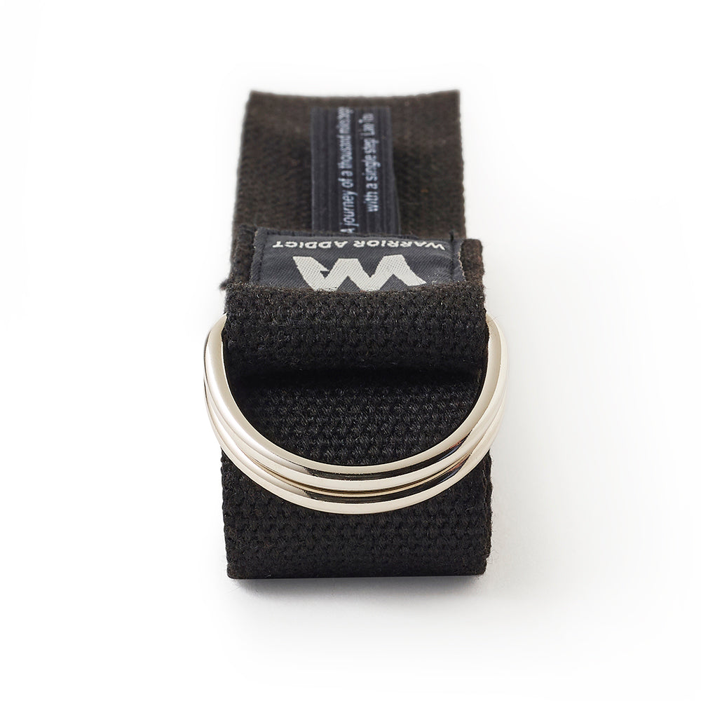 black yoga strap folded with sliver ring and warrior addict branding