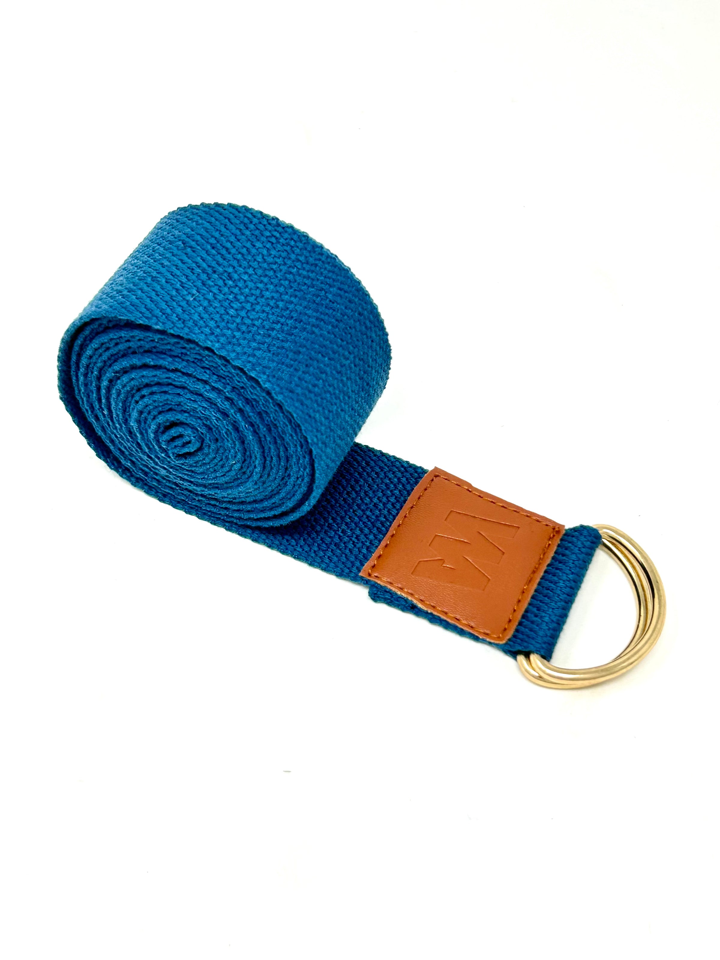 Rolled blue yoga strap with brown leather accent and metal rings.
