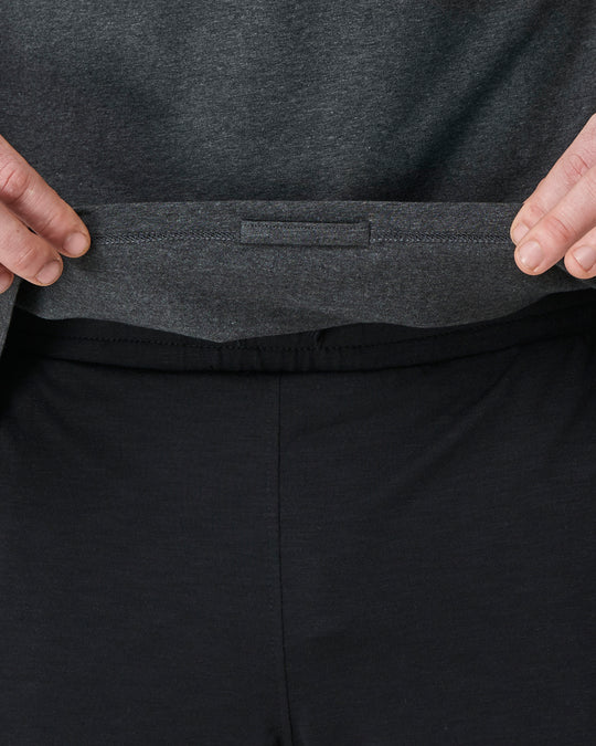 detil of a grey yoga top showing a hidden inside loop to tie too chords
