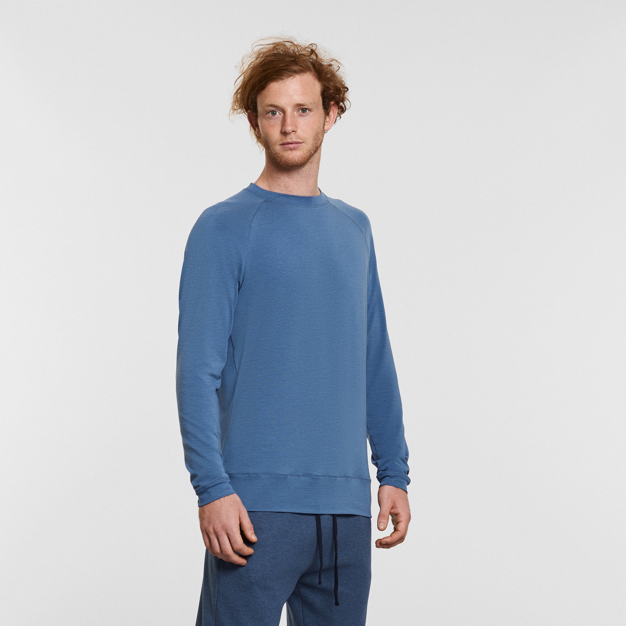 man wearing blue long sleeved yoga top by warrior addict 