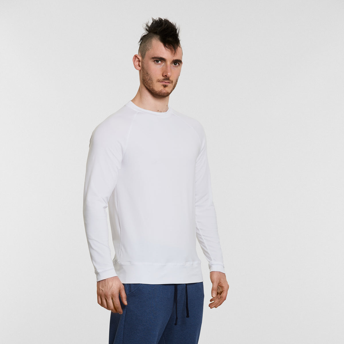 man wearing long sleeved mens yoga top in white by warrior addict 