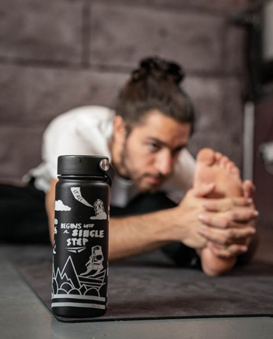 mens water bottle placed in front of man doing yoga 