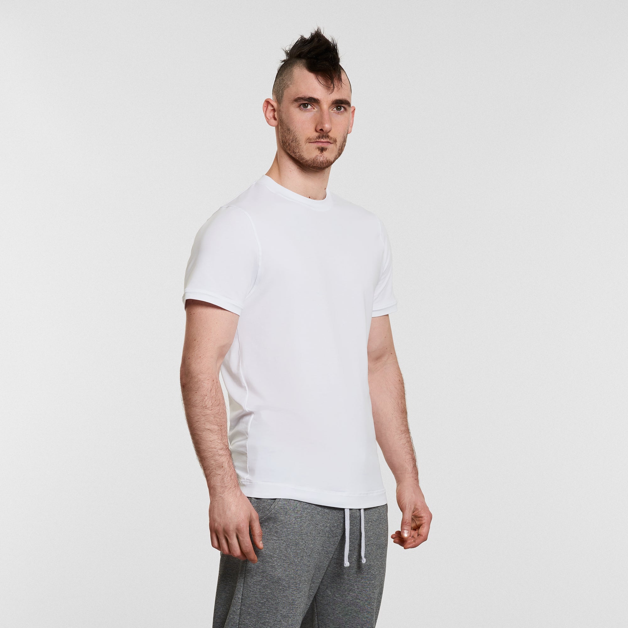 man wearing warrior addict mens yoga t-shirt and grey yoga pants 