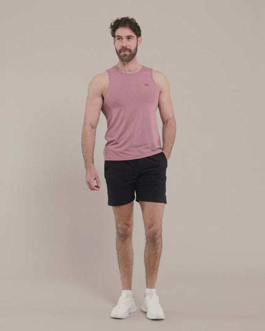male model wearing pink warror additc tank top with black shorts 