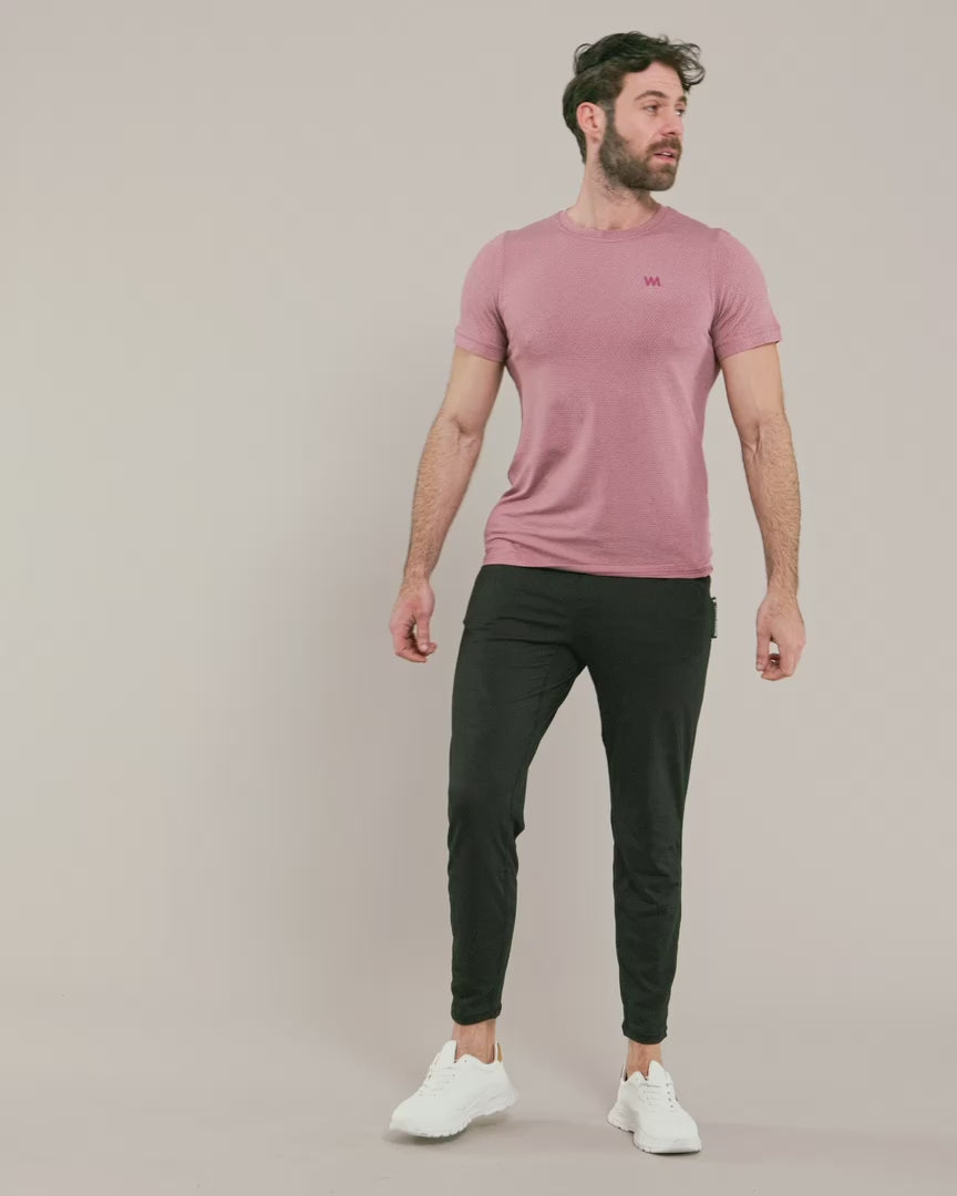 male model wearing warrior addict mens joggers in black and a pink t-shirt 