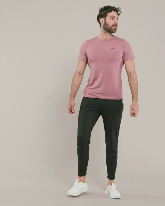 male model wearing warrior addict mens joggers in black and a pink t-shirt 