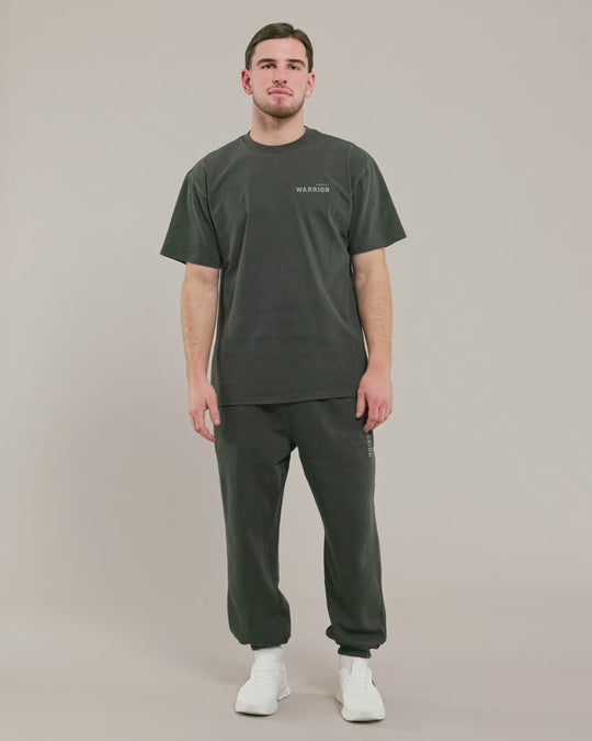 male model wearing warrior addict black over sized t shirt and joggers 