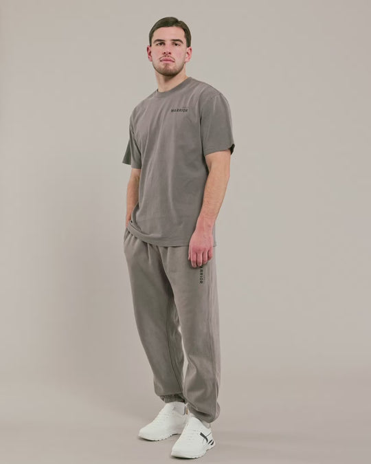 male model wearing grey warror addict over sized t-shirt and joggers 