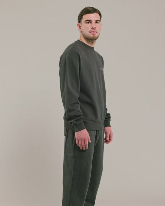 male madel wearing warrior addict black crew neck sweater and joggers