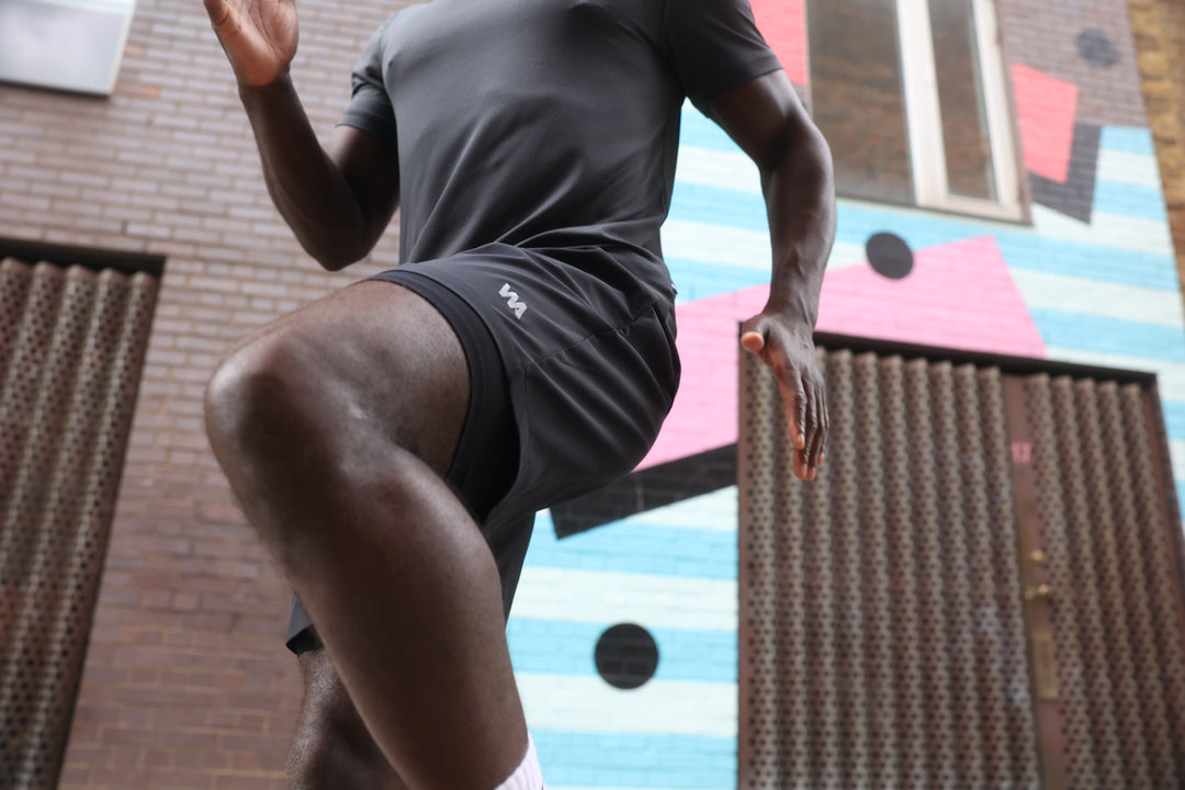 Man in Warrior Addict's Warrior Skin activewear  in black running outdoors 