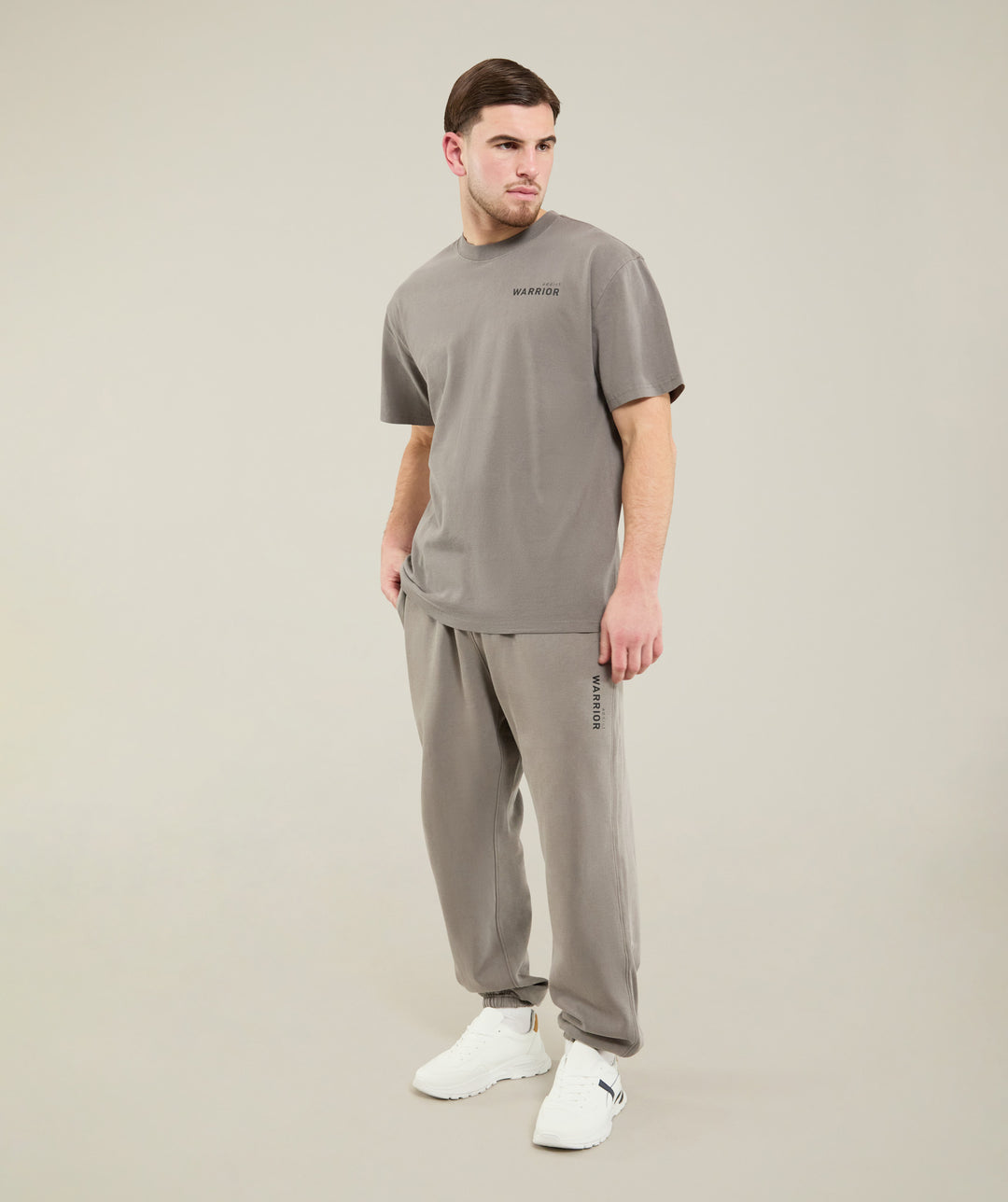 Person wearing a gray warrior addict outfit on a plain background