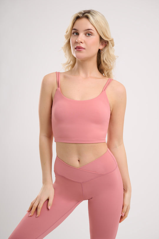 pink womens yoga top by NE Activwear  modelled  by a blonde woman