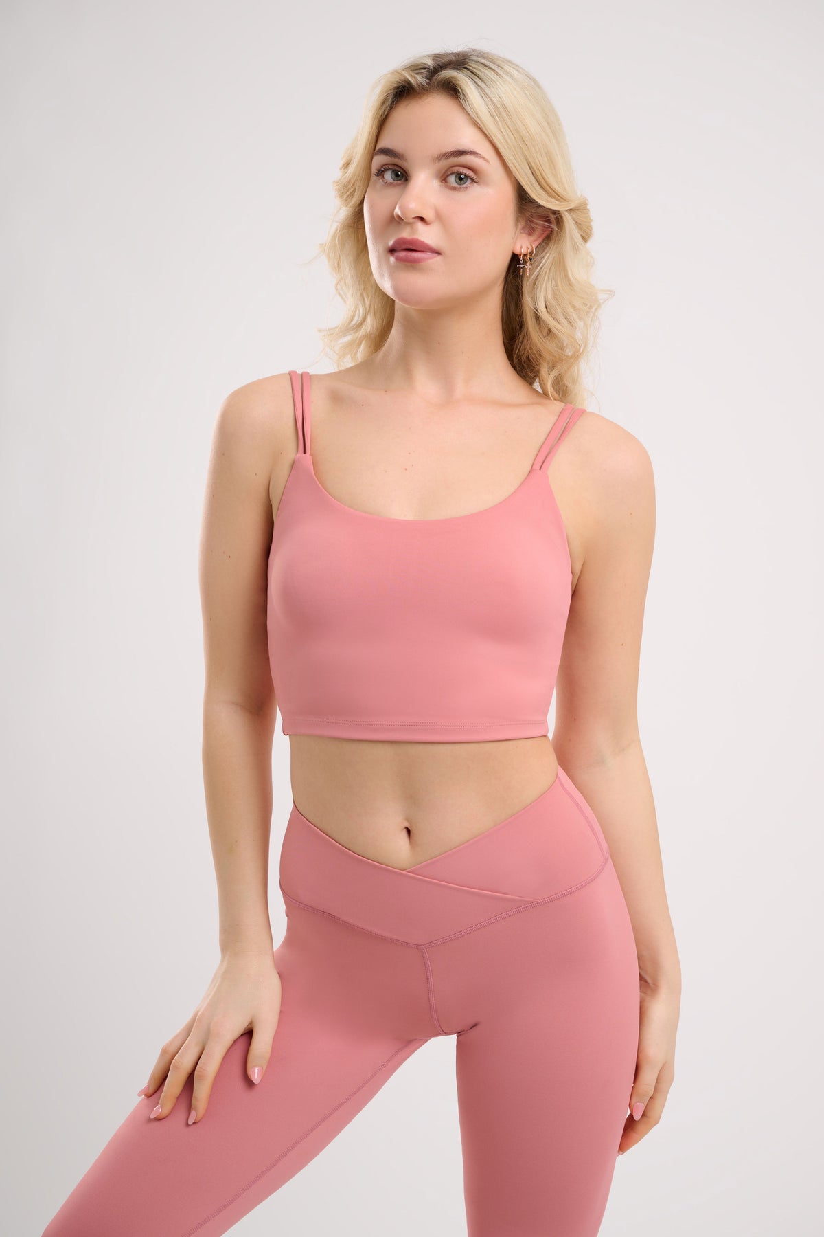 pink womens yoga top by NE Activwear  modelled  by a blonde woman