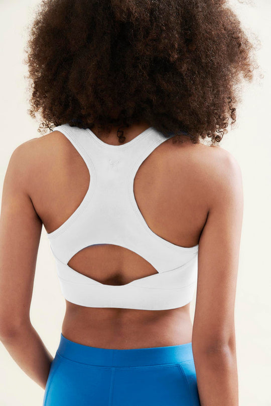 back of womans yoga crop top in white
